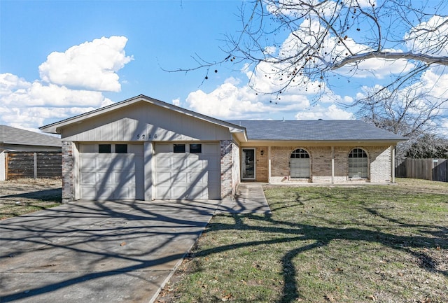 ranch-style house with a garage and a front lawn