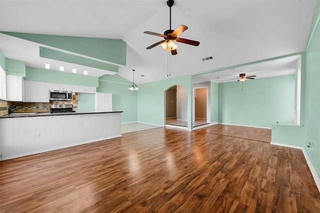 unfurnished living room with ceiling fan, high vaulted ceiling, sink, and light hardwood / wood-style floors