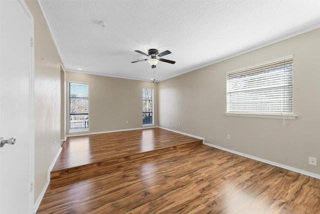 empty room featuring hardwood / wood-style floors, a textured ceiling, and ceiling fan