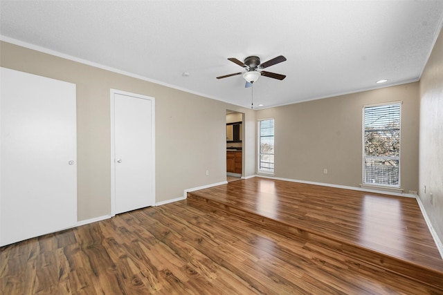 spare room with ornamental molding, hardwood / wood-style floors, and ceiling fan