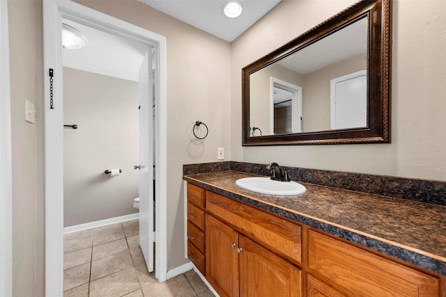 bathroom with vanity, toilet, and tile patterned flooring