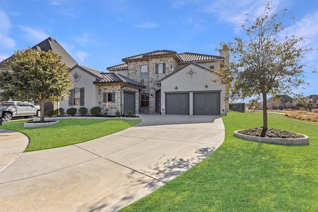 mediterranean / spanish house featuring a garage and a front yard