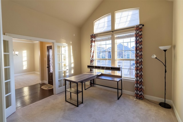 carpeted office with vaulted ceiling and french doors