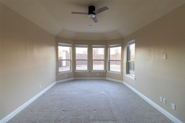 unfurnished room with ceiling fan, light colored carpet, and vaulted ceiling