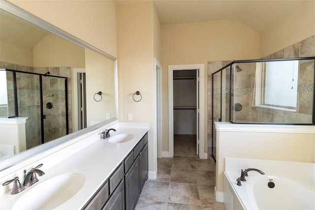 bathroom featuring vaulted ceiling, separate shower and tub, and vanity