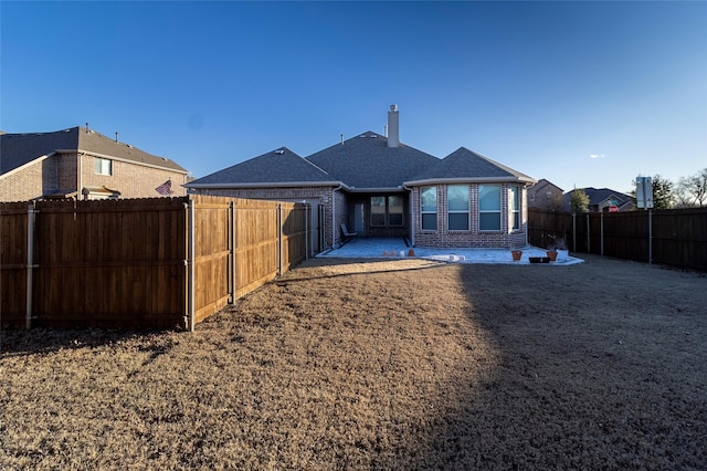 rear view of property featuring a patio