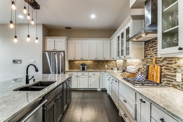 kitchen with white cabinetry, sink, wall chimney exhaust hood, and appliances with stainless steel finishes