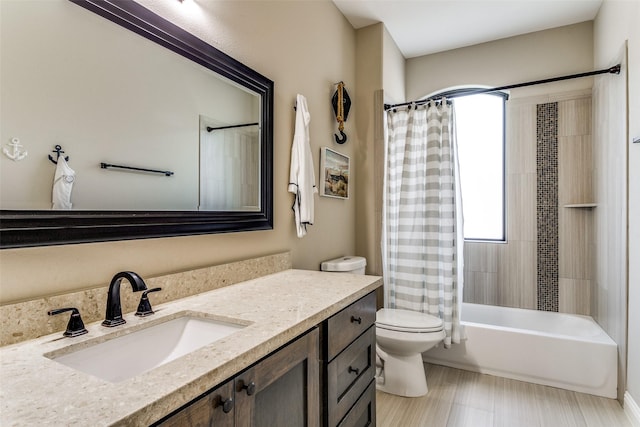 full bathroom with shower / tub combo, vanity, and toilet