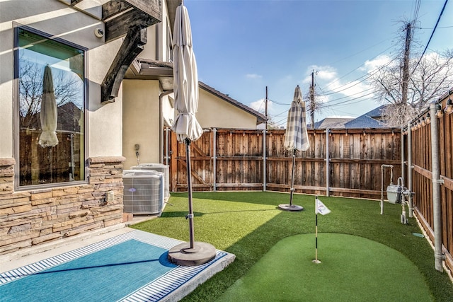 view of yard featuring cooling unit and a patio