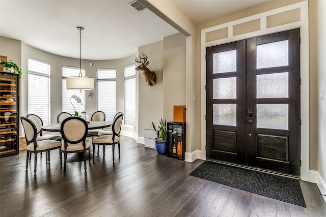 entrance foyer featuring dark hardwood / wood-style floors and french doors