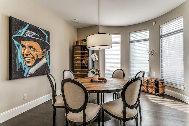 dining space with wine cooler and dark hardwood / wood-style flooring