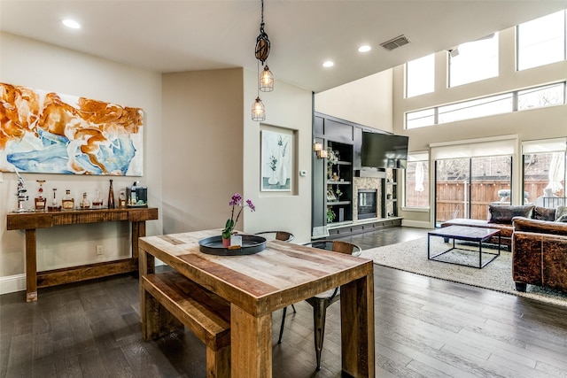 dining area featuring dark hardwood / wood-style floors and a fireplace