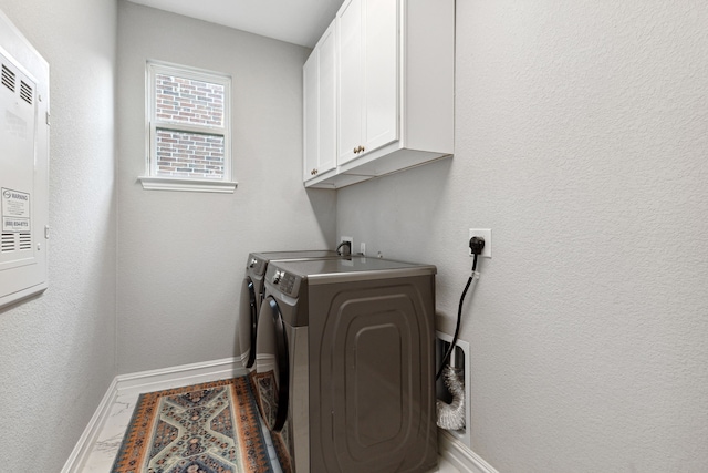 laundry room with cabinets and washing machine and dryer