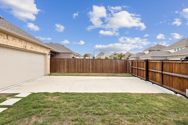 view of yard with a garage and a patio