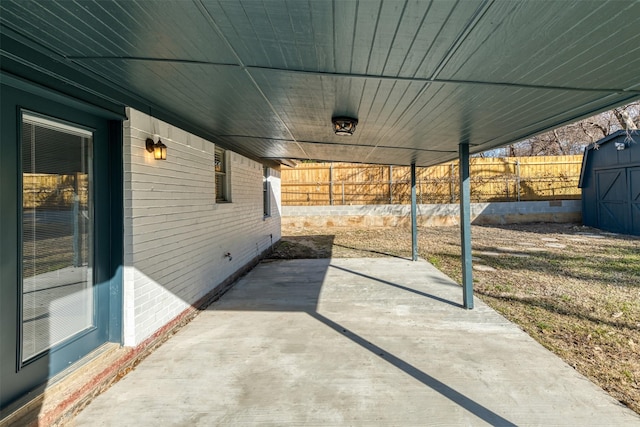 view of patio / terrace featuring a storage unit