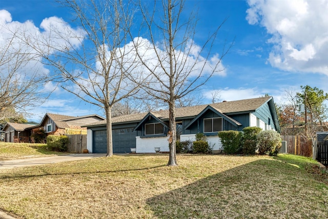 single story home featuring a garage and a front lawn