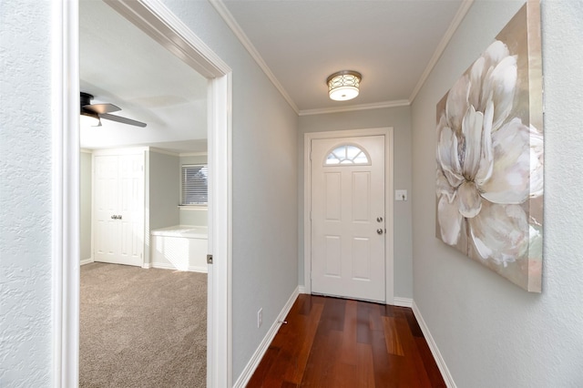 doorway featuring crown molding, ceiling fan, and dark hardwood / wood-style floors