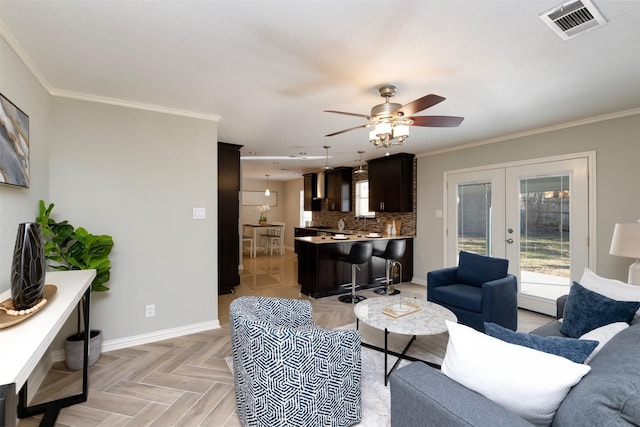 living room with french doors, ceiling fan, ornamental molding, and light parquet flooring