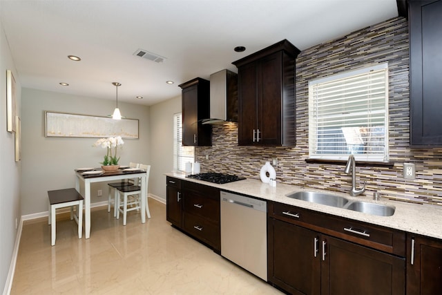 kitchen with pendant lighting, wall chimney range hood, sink, dishwasher, and black gas stovetop