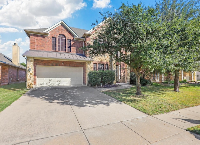 view of front of home with a garage and a front lawn