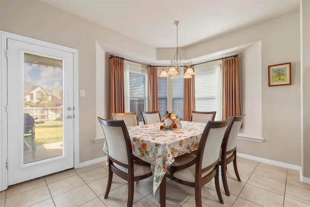 dining room with a healthy amount of sunlight, a chandelier, and light tile patterned floors