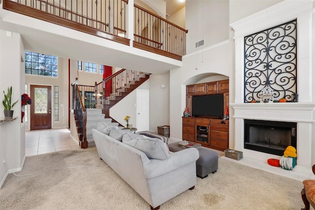 carpeted living room featuring a high ceiling