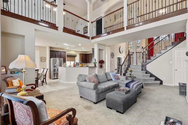 living room with light carpet and a towering ceiling