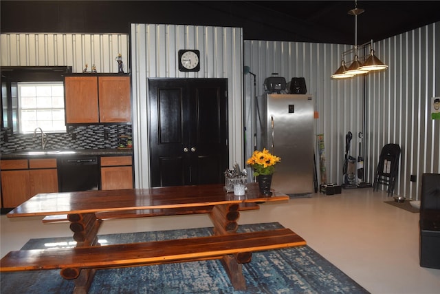 kitchen with sink, stainless steel fridge, black dishwasher, pendant lighting, and decorative backsplash