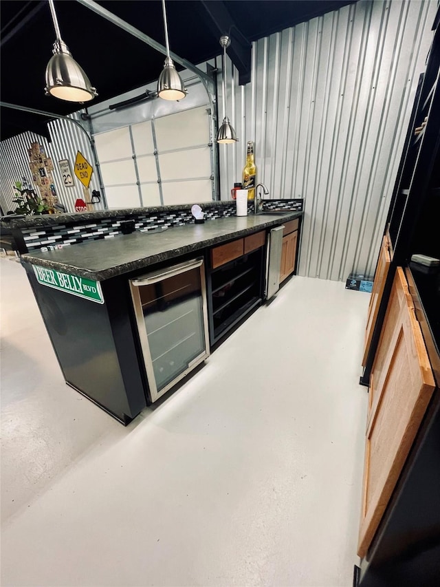 bar featuring pendant lighting, wine cooler, and concrete floors