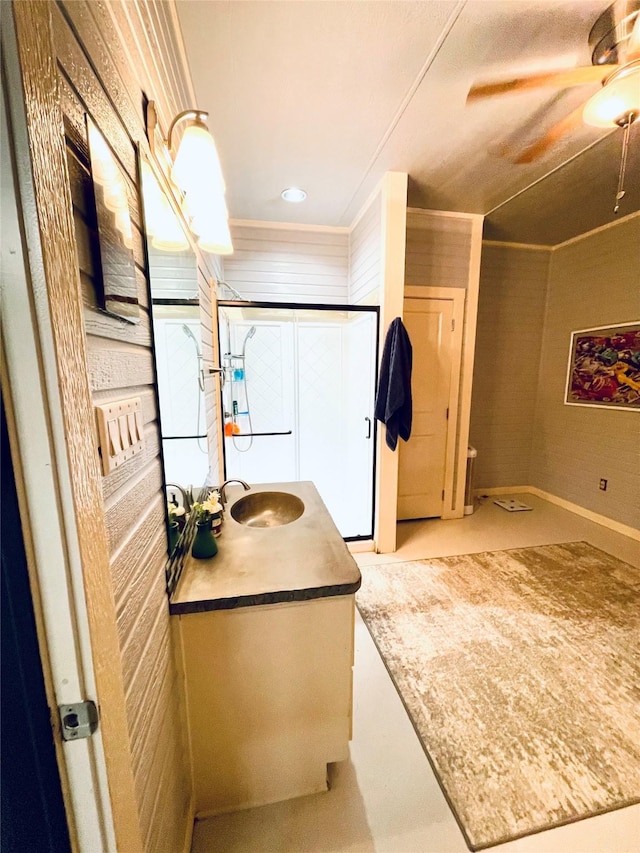 bathroom with concrete flooring, ornamental molding, vanity, and ceiling fan