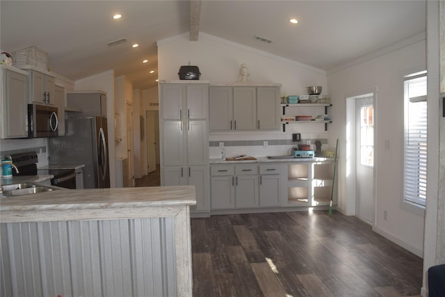 kitchen with sink, tasteful backsplash, lofted ceiling with beams, dark hardwood / wood-style flooring, and stainless steel appliances