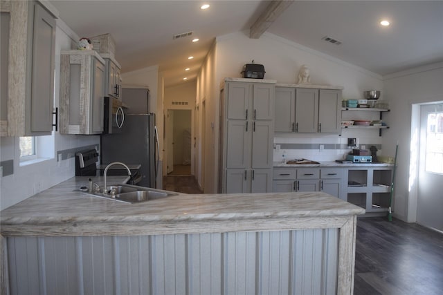 kitchen with sink, decorative backsplash, lofted ceiling with beams, and stainless steel appliances