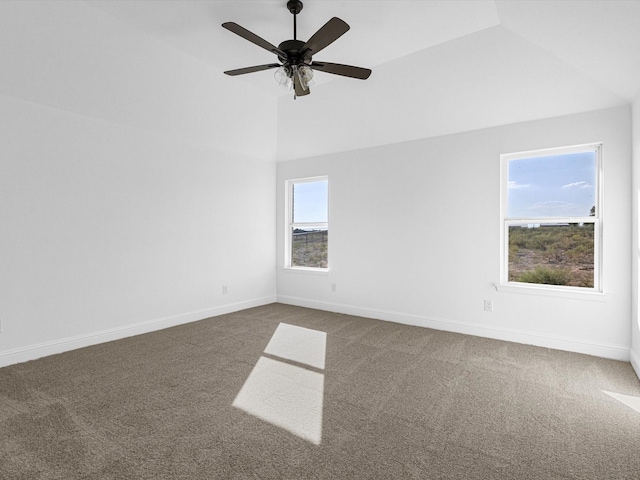 carpeted spare room with lofted ceiling, a healthy amount of sunlight, and ceiling fan