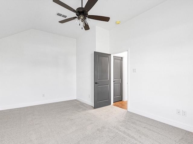 carpeted spare room with lofted ceiling and ceiling fan