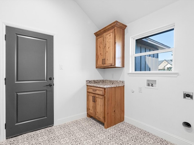 laundry room featuring hookup for a washing machine, hookup for an electric dryer, cabinets, and light tile patterned floors