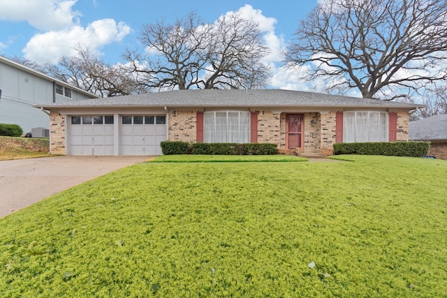 view of front of home with a garage and a front lawn