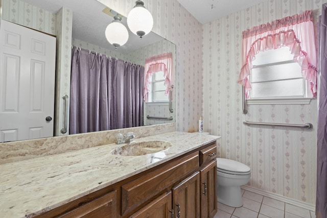 bathroom featuring vanity, tile patterned floors, a textured ceiling, and toilet