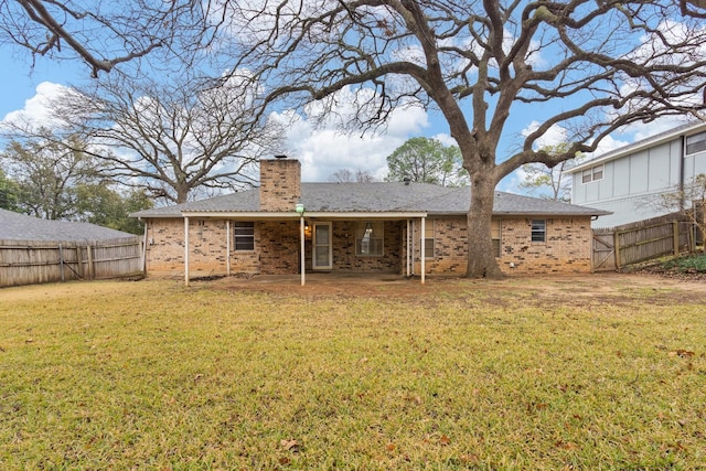 back of house featuring a patio and a lawn