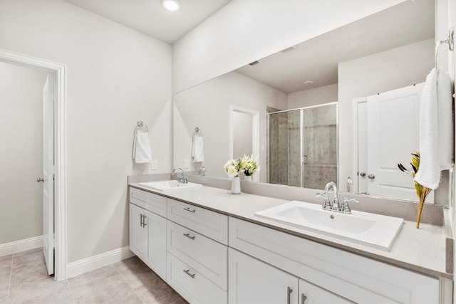 bathroom with vanity, a shower with door, and tile patterned flooring