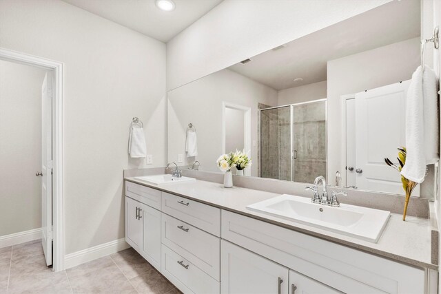 bathroom with a shower with door and tile patterned floors