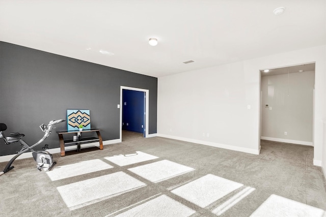 interior space featuring carpet floors, visible vents, and baseboards