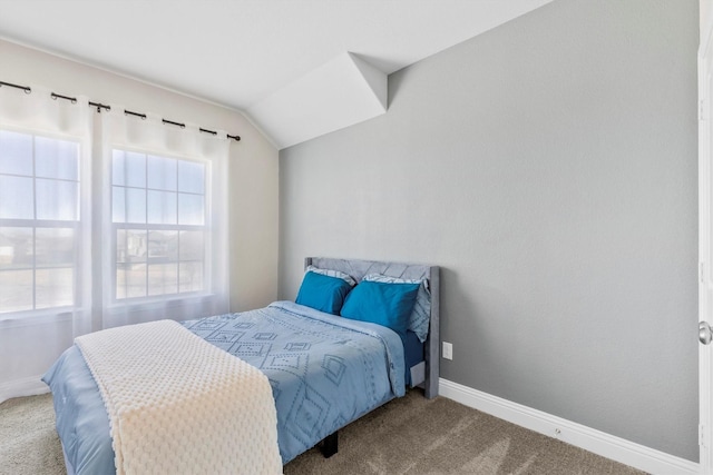 bedroom featuring lofted ceiling, carpet, and baseboards