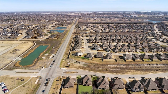 birds eye view of property featuring a water view and a residential view