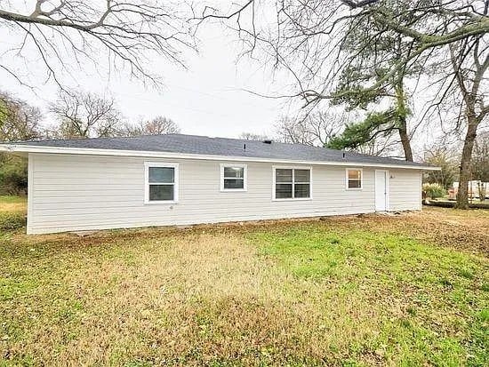 rear view of house with a lawn