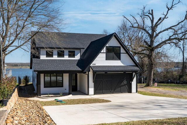 view of front of home featuring a garage and a water view