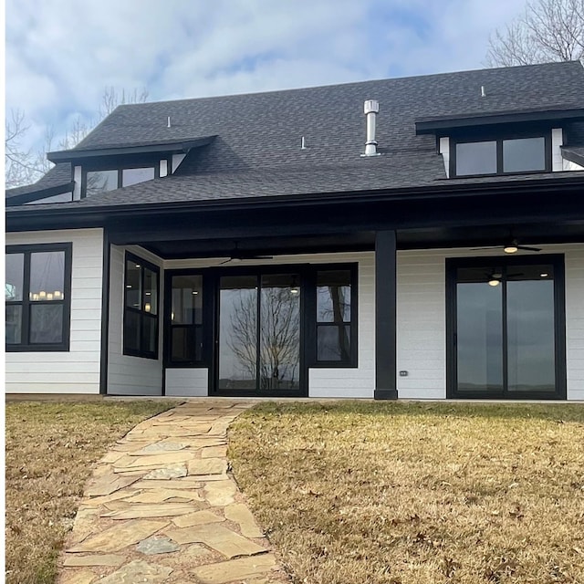 rear view of property with a yard and ceiling fan