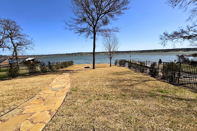 view of yard with a water view and fence