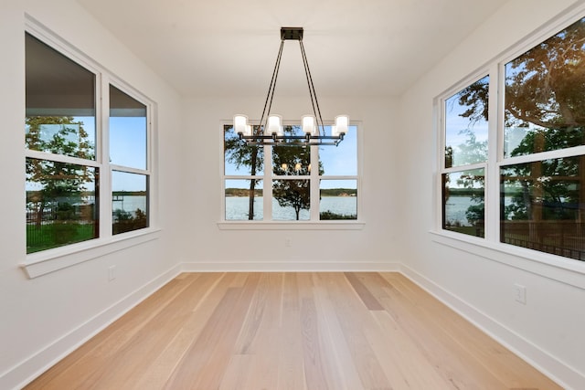 13590 Park Harbor Dr, Eustace, TX 75124 - unfurnished dining area with a chandelier, light wood-style floors, and baseboards