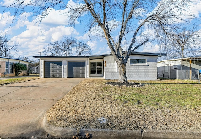 ranch-style house featuring a garage and a front lawn