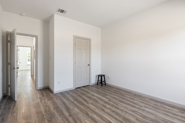 empty room with dark wood-type flooring